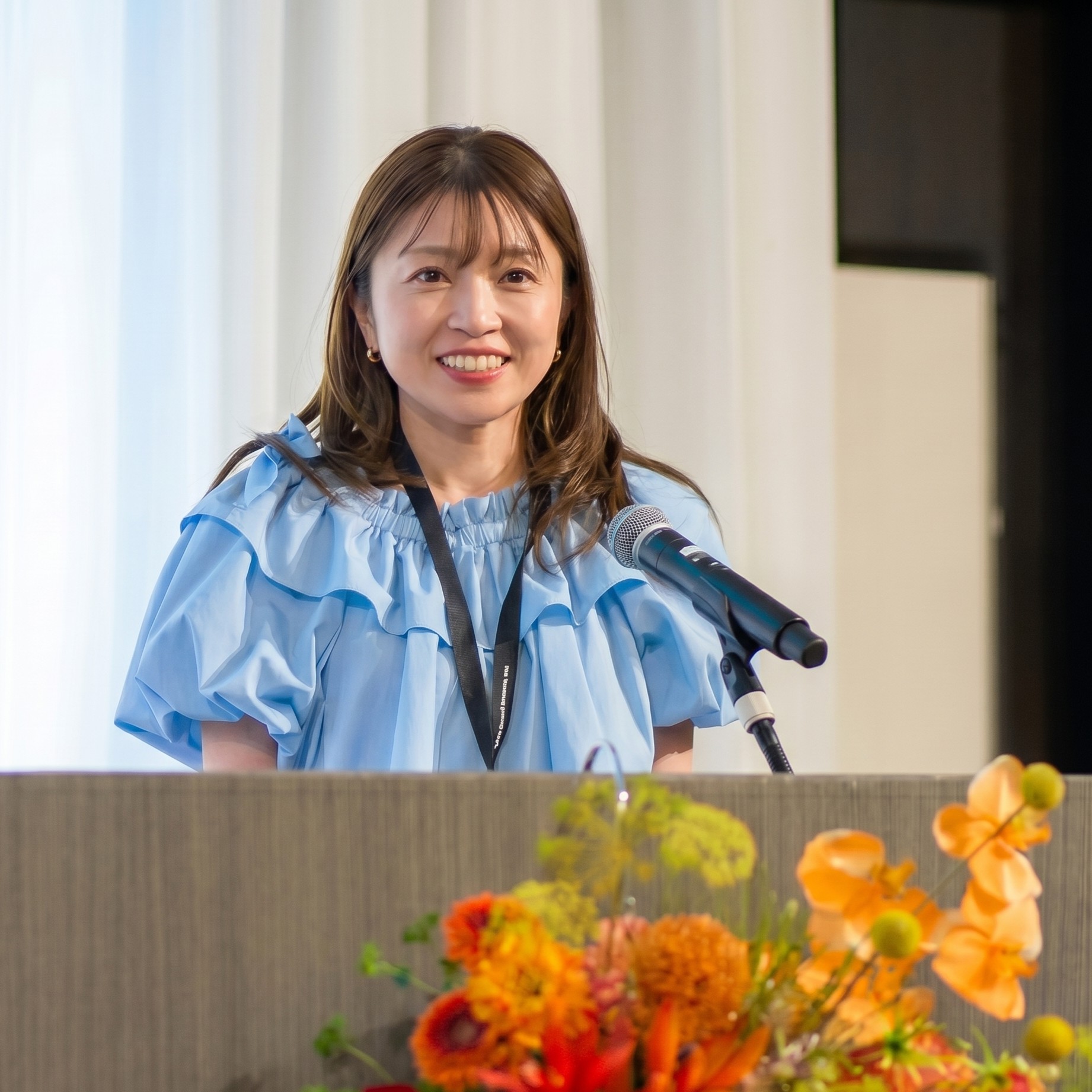 Re:Design株式会社 取締役 佐々木裕実が登壇する様子
